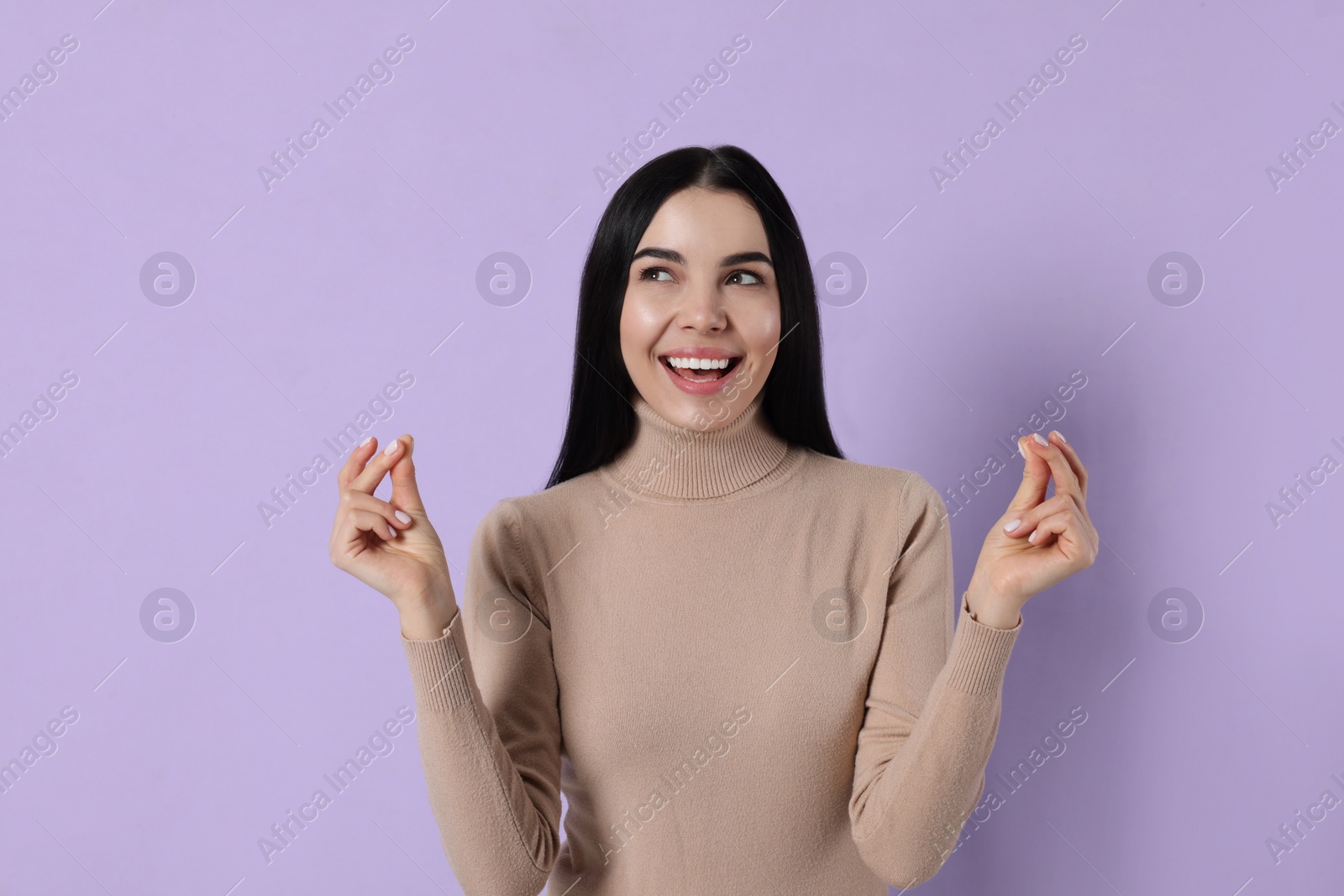 Photo of Young woman snapping fingers on violet background