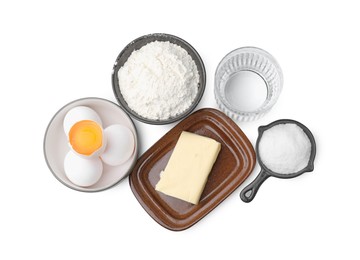 Photo of Eggs, butter, flour, salt and water isolated on white, top view. Ingredients for puff pastry dough