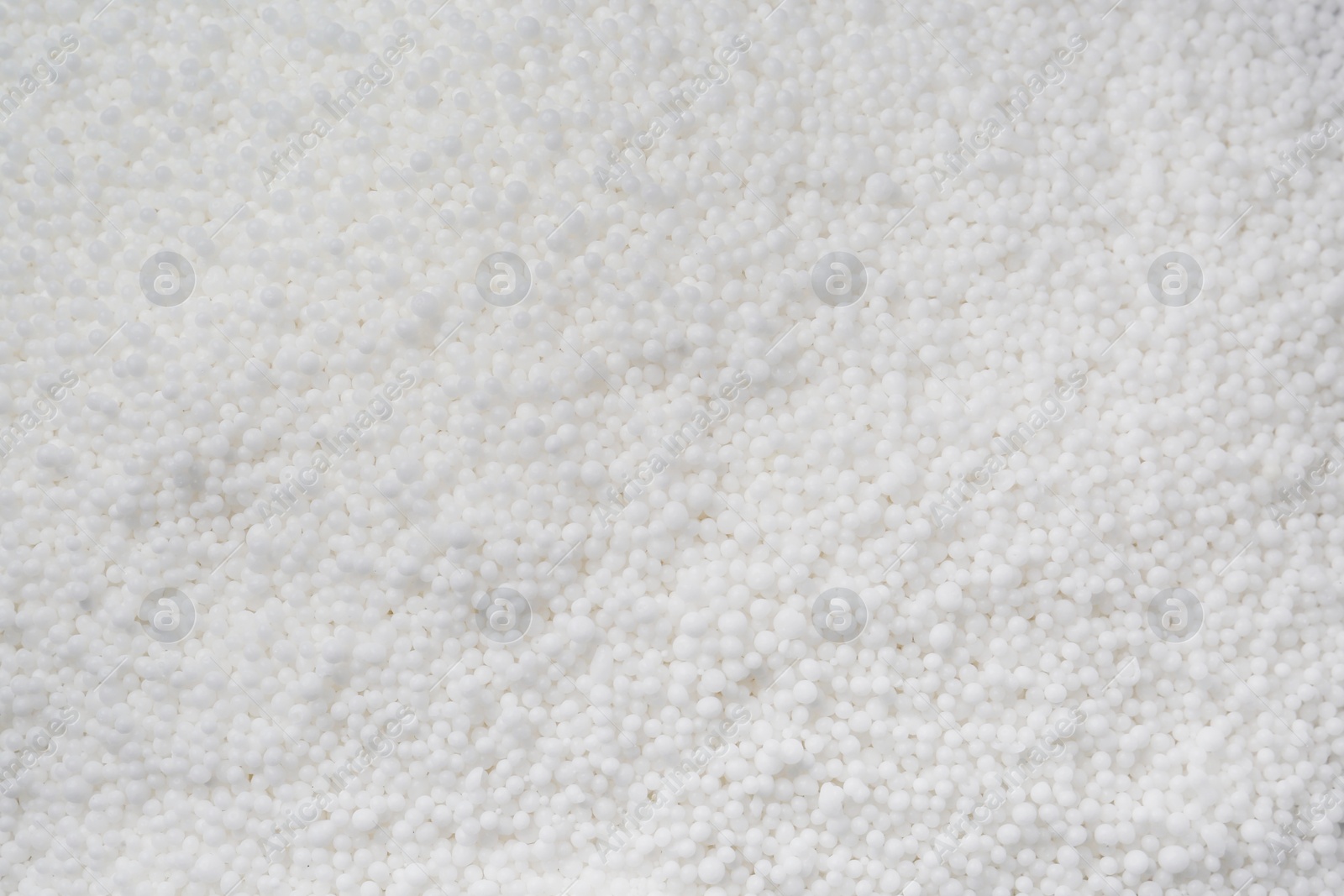 Photo of Granular mineral fertilizer as background, closeup view