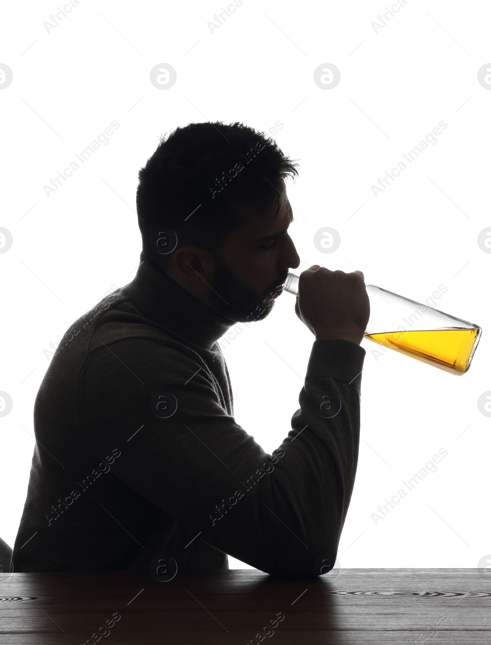 Photo of Silhouette of addicted man drinking alcohol on white background