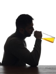 Silhouette of addicted man drinking alcohol on white background