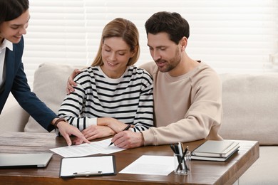Photo of Professional notary working with couple in office