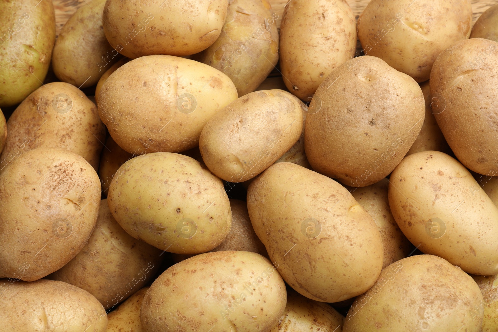 Photo of Fresh raw potatoes as background, top view