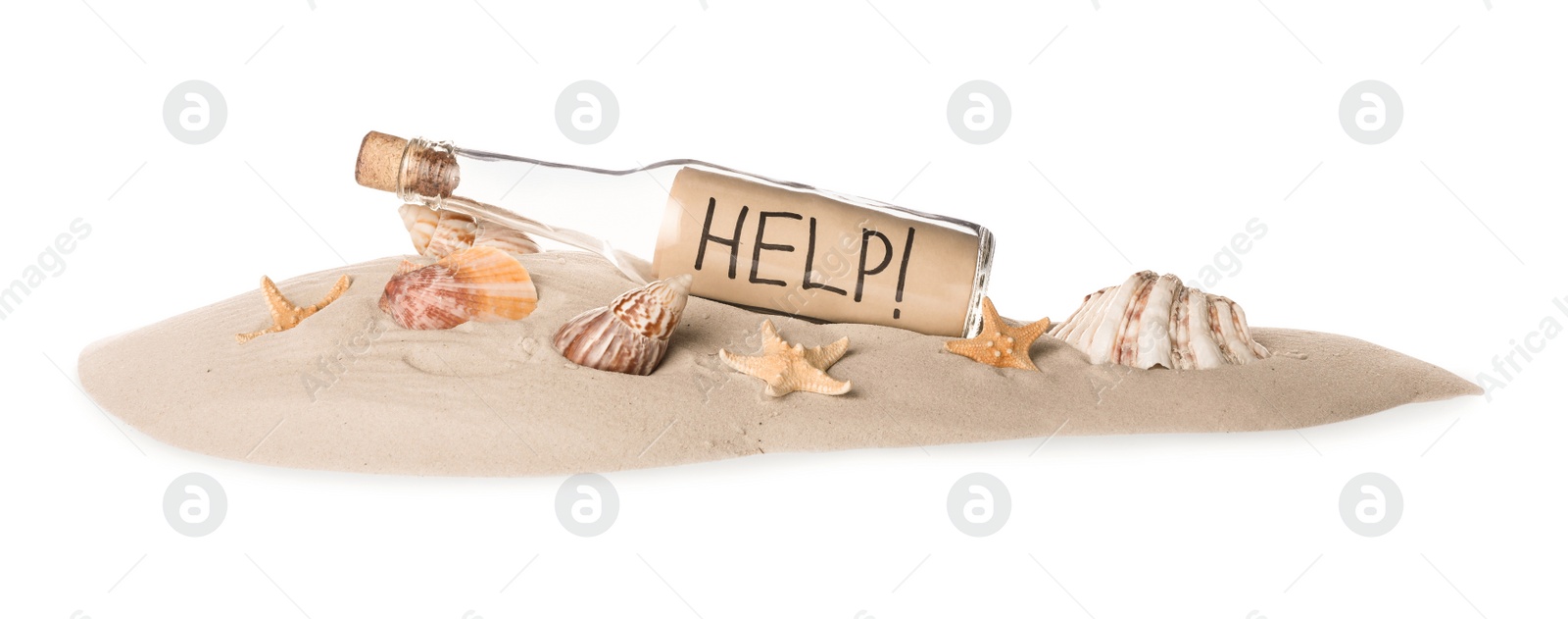 Photo of Corked glass bottle with Help note and seashells on sand against white background