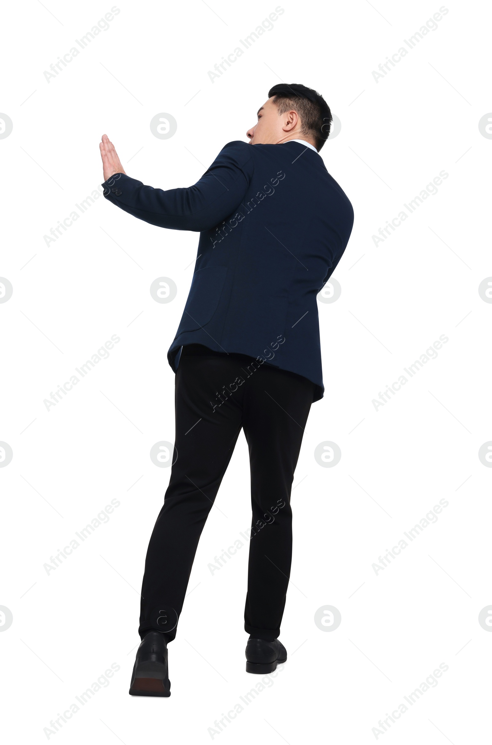 Photo of Scared businessman in suit posing on white background