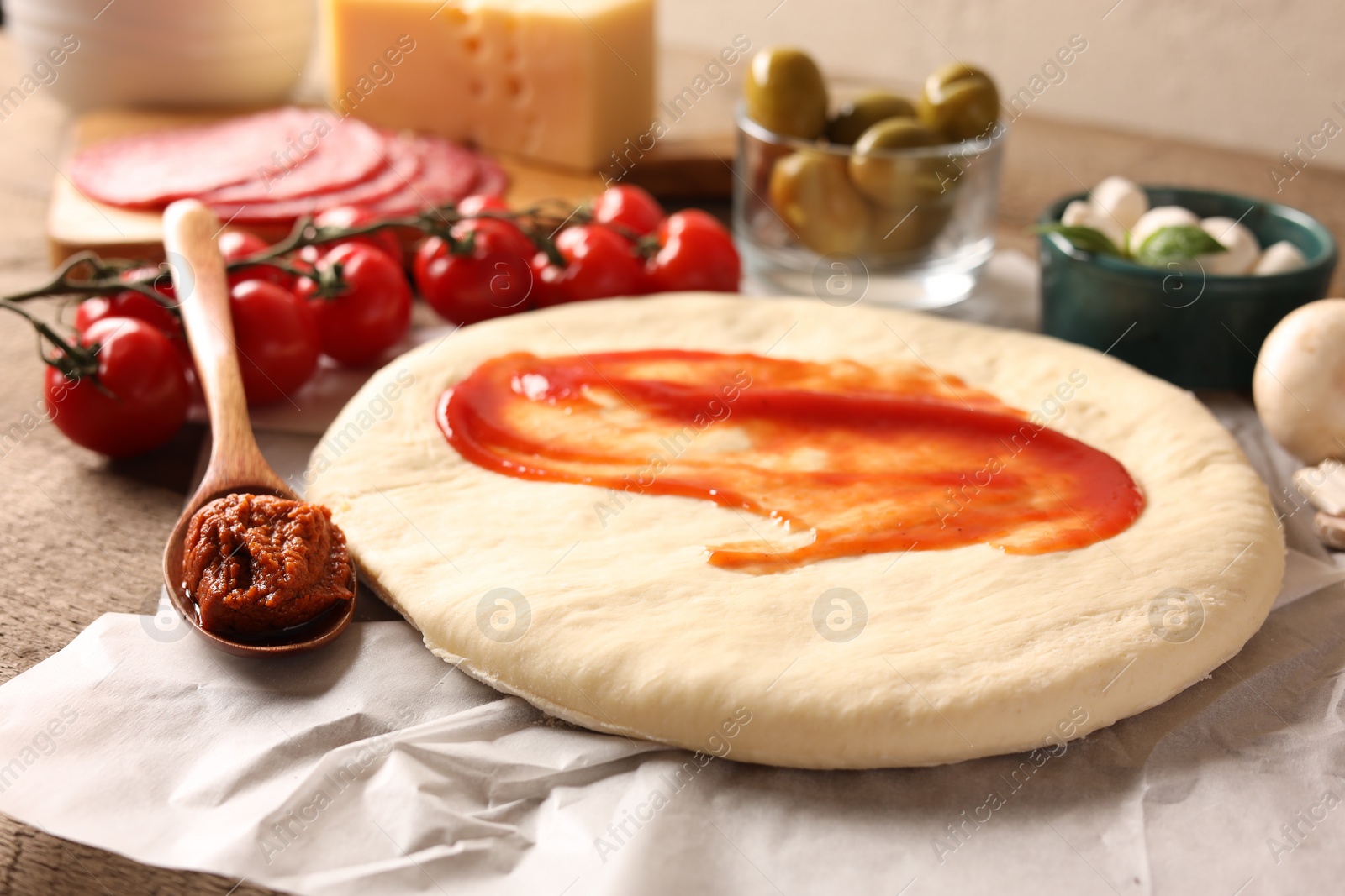 Photo of Pizza dough and products on table, closeup