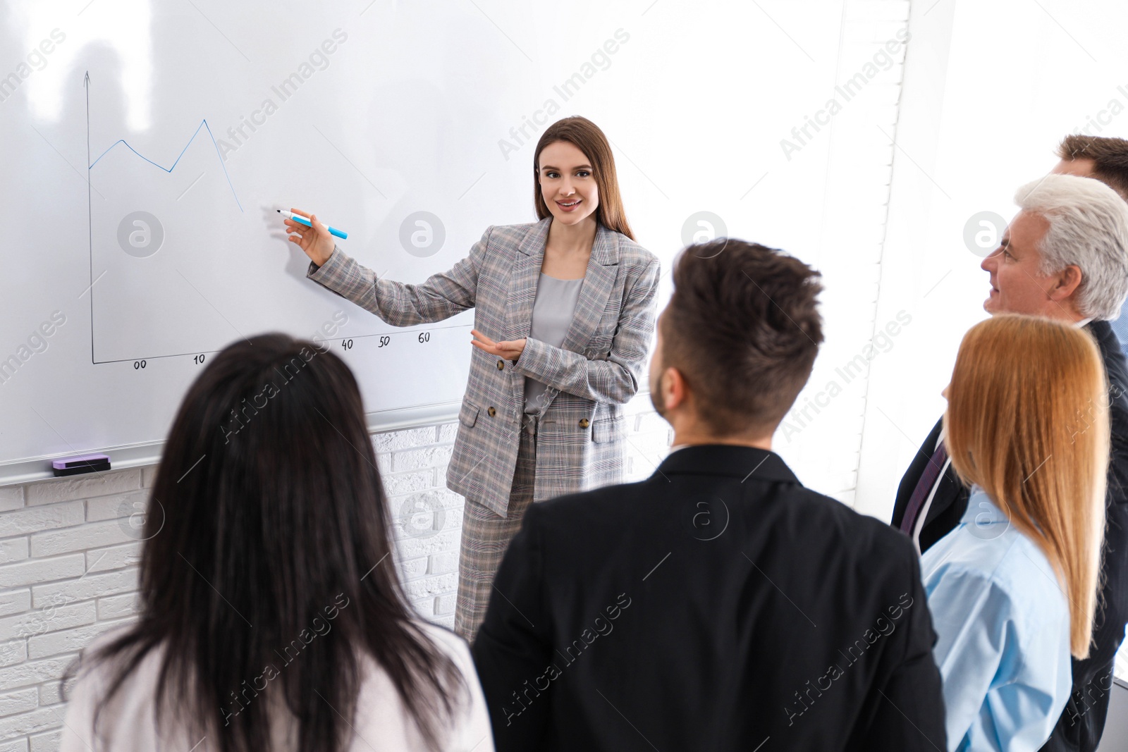 Photo of Professional business trainer working with people in office