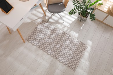 Photo of Stylish rug with pattern on floor in room, above view