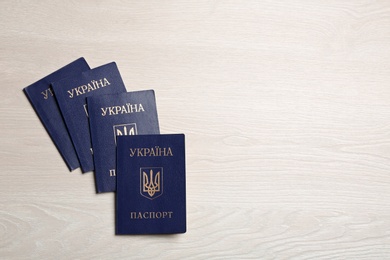 Photo of Ukrainian internal passports on wooden background, top view. Space for text