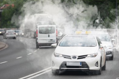 Image of Environmental pollution. Air contaminated with fumes in city. Cars surrounded by exhaust on road