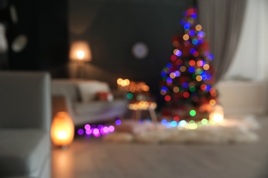 Photo of Blurred view of stylish room interior with decorated Christmas tree