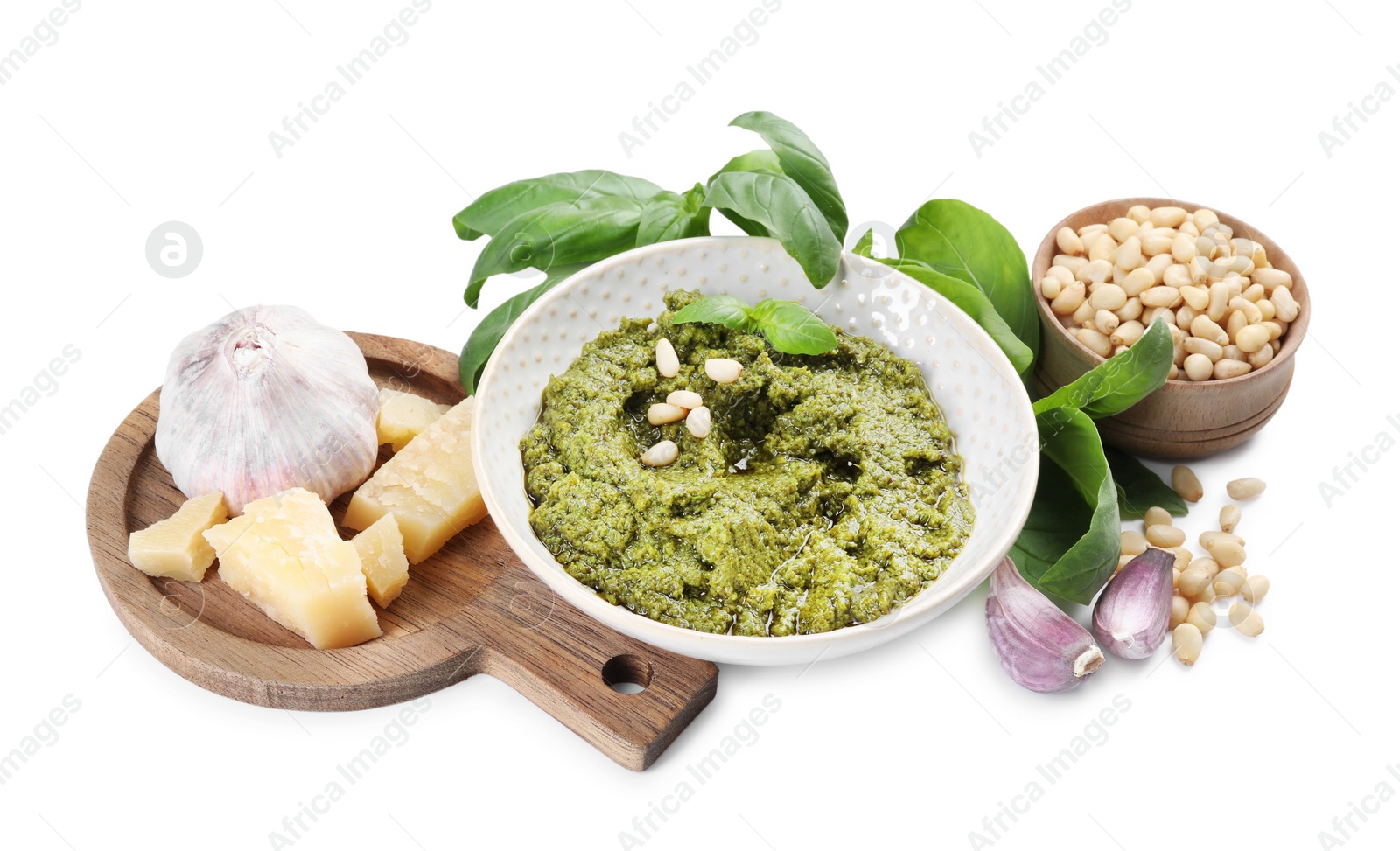 Photo of Fresh tasty pesto sauce and ingredients isolated on white