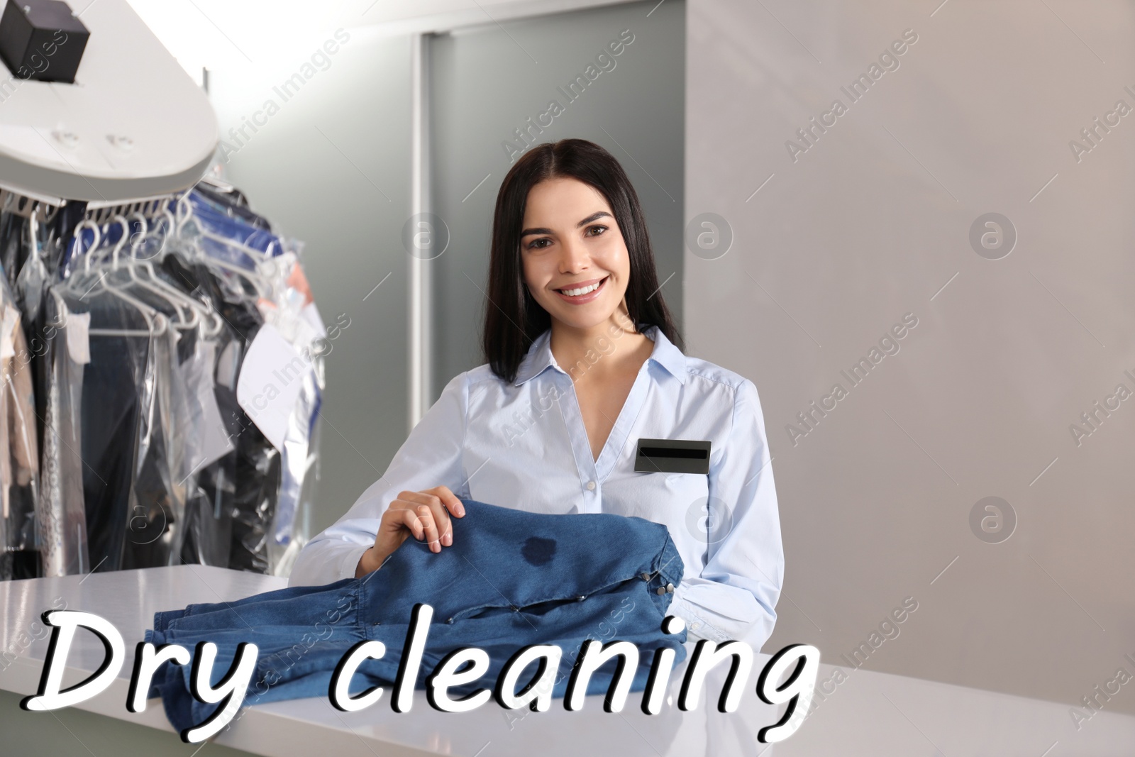 Image of Female worker with stained clothes at dry-cleaner's