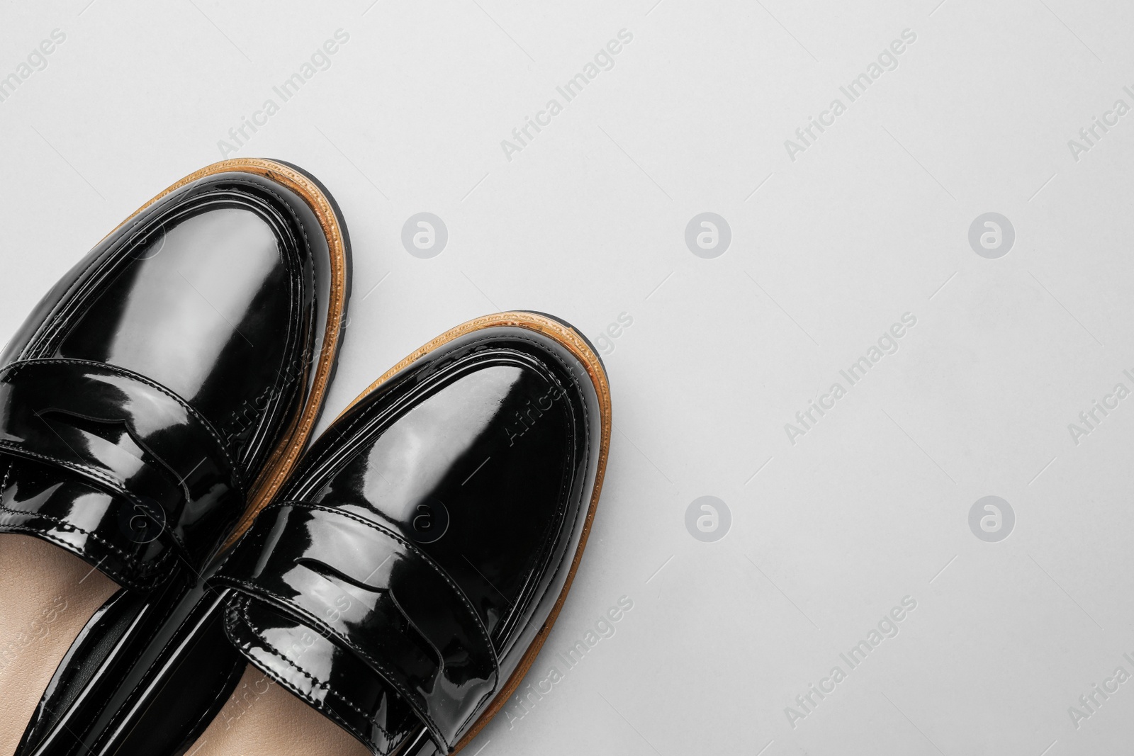 Photo of Pair of stylish female shoes on light grey background, top view. Space for text