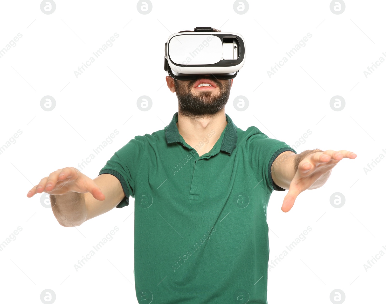 Photo of Emotional young man playing video games with virtual reality headset isolated on white