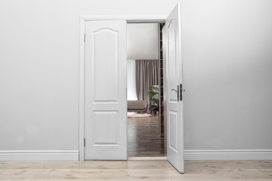 Photo of Stylish room interior, view through open door