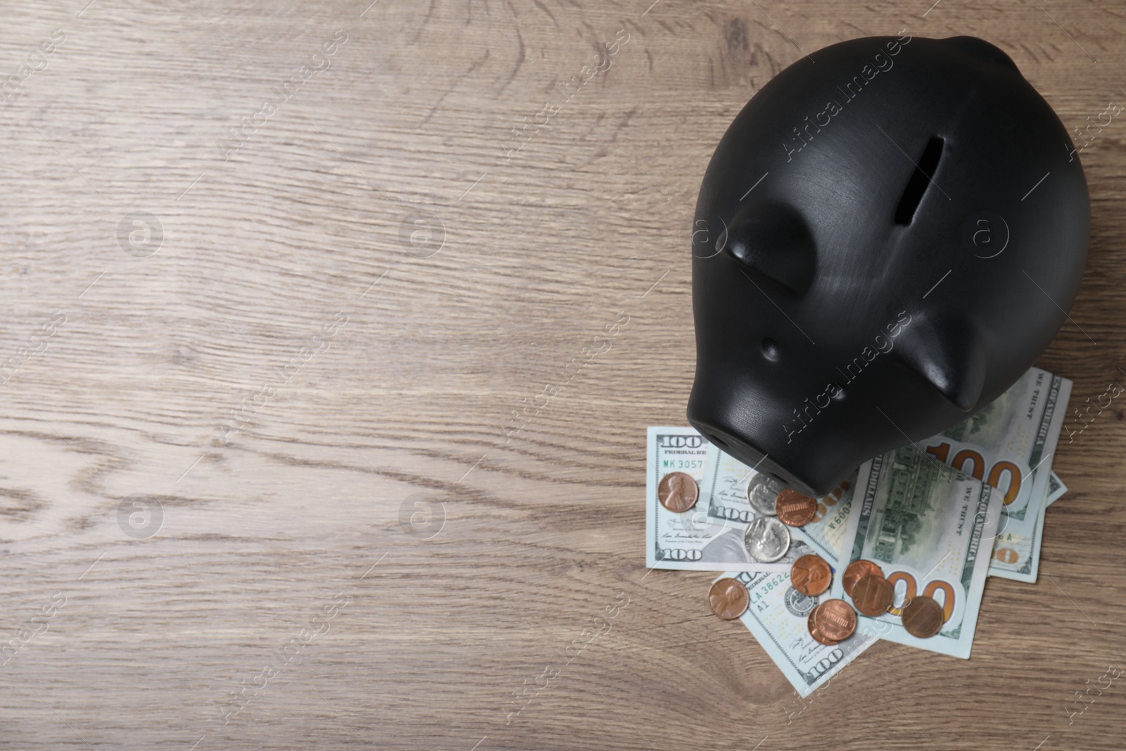 Photo of Flat lay composition with piggy bank on wooden table, space for text. Money savings