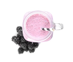 Tasty fresh milk shake with blackberries on white background, top view