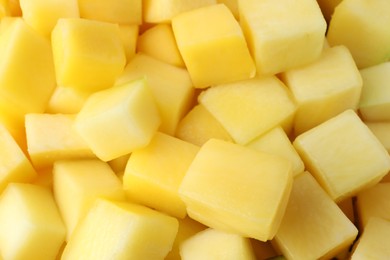 Many delicious mango cubes as background, closeup