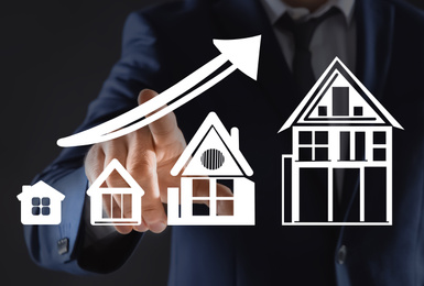 Image of Real estate agent demonstrating prices at housing market. Man pointing on graph illustration, closeup
