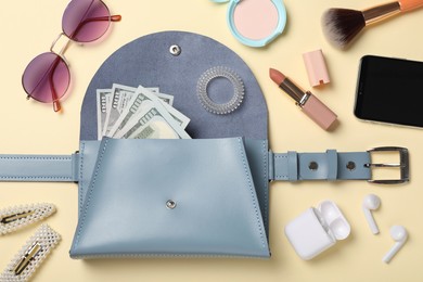 Flat lay composition with stylish woman's bag on beige background