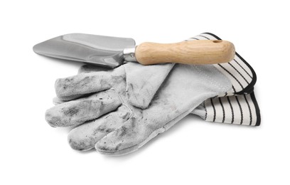 Photo of Pair of color gardening gloves and trowel isolated on white