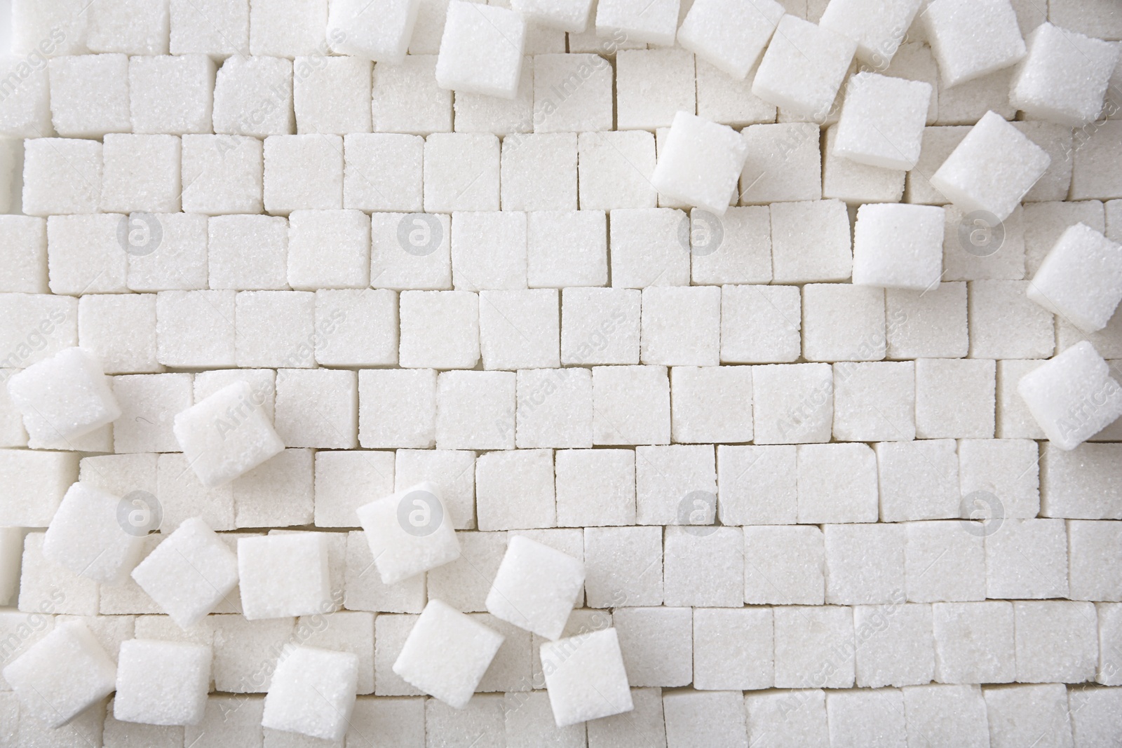 Photo of Refined sugar cubes as background, top view