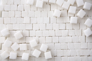 Refined sugar cubes as background, top view