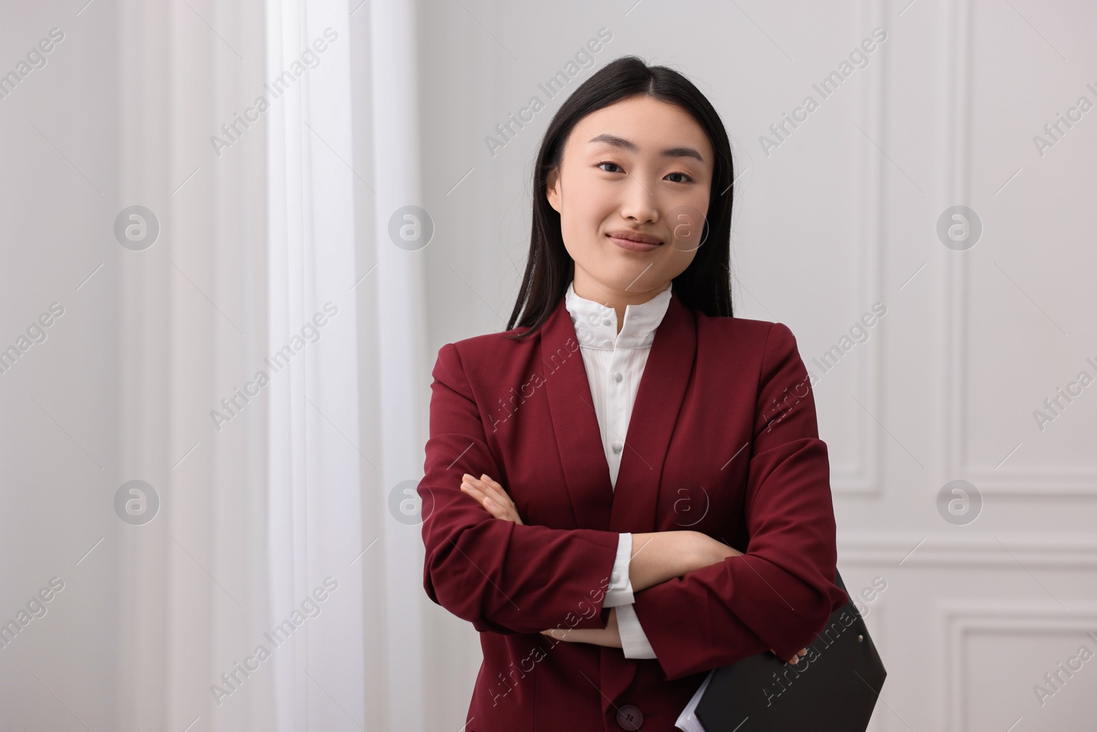 Photo of Portrait of happy notary with crossed arms in office. Space for text