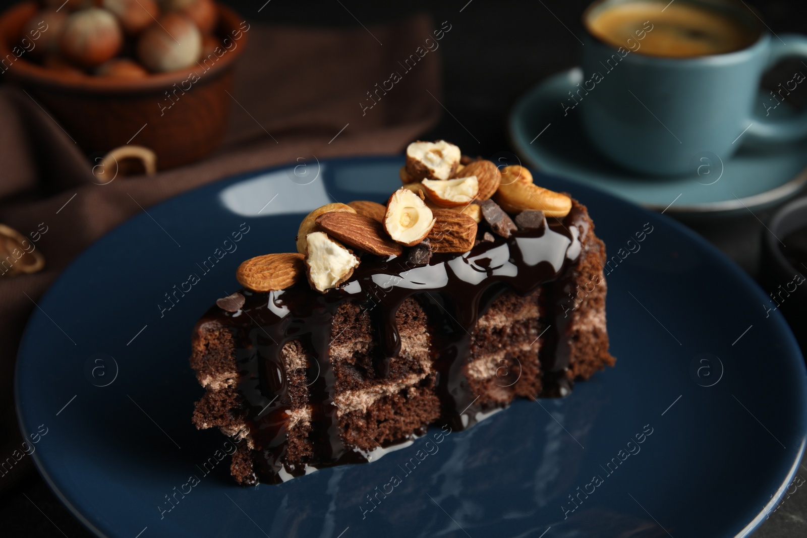 Photo of Piece of tasty homemade chocolate cake with nuts on plate, closeup