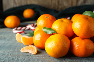 Photo of Tasty fresh tangerines on blue wooden table. Christmas celebration