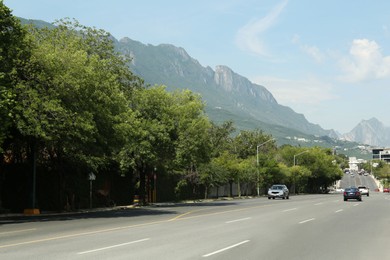 Photo of Picturesque view of mountains and highway with cars