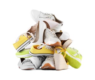 Photo of Pile of different female shoes isolated on white