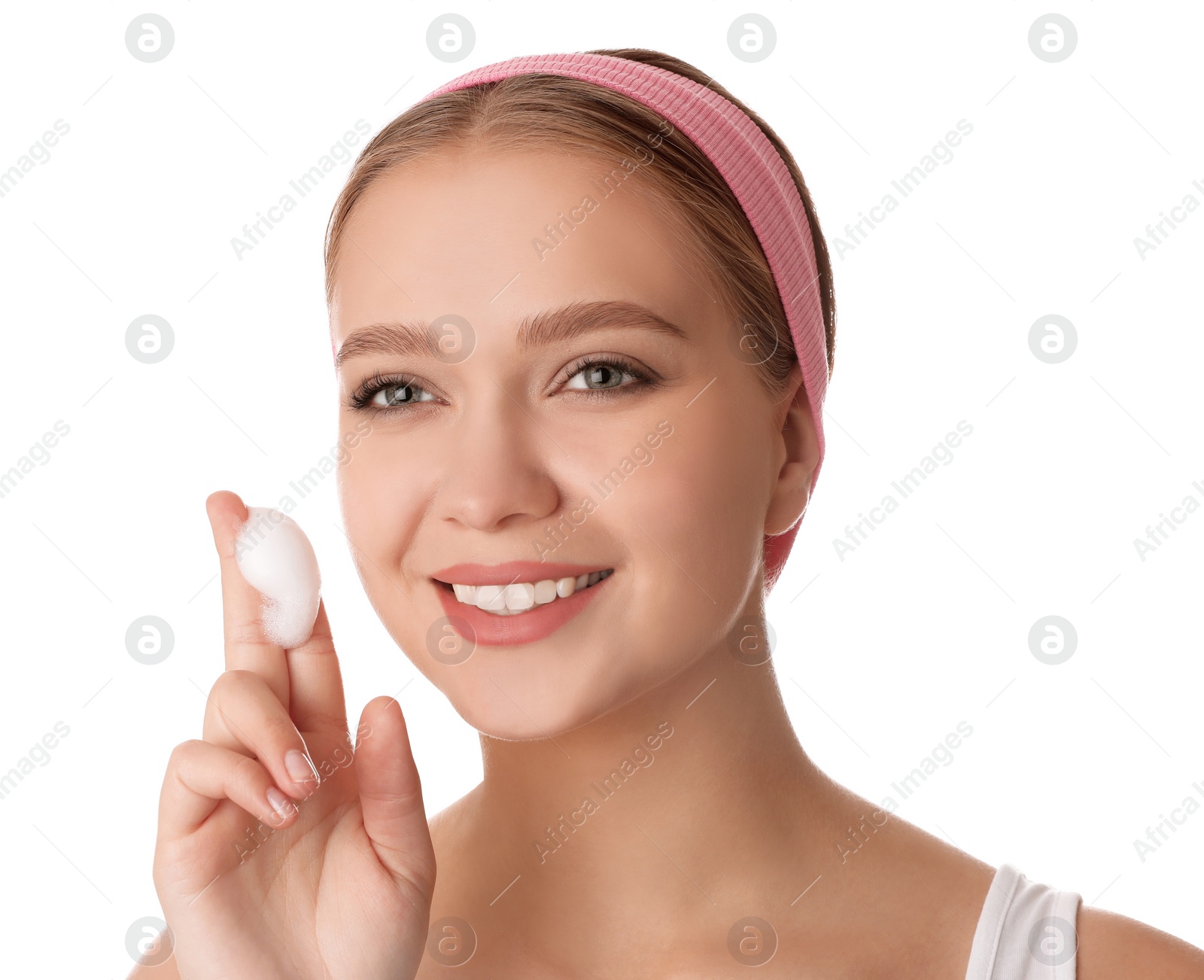 Photo of Young woman washing face with cleansing foam on white background. Cosmetic product