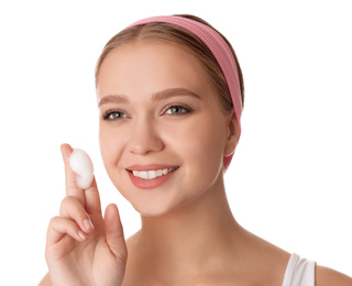 Photo of Young woman washing face with cleansing foam on white background. Cosmetic product