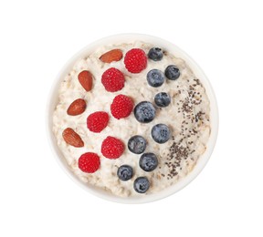 Photo of Tasty boiled oatmeal with berries, almonds and chia seeds in bowl isolated on white, top view