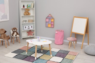 Photo of Child`s playroom with different toys and modern furniture. Stylish kindergarten interior