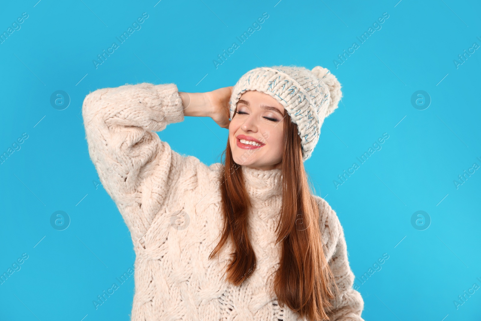 Photo of Young woman wearing Christmas sweater on blue background