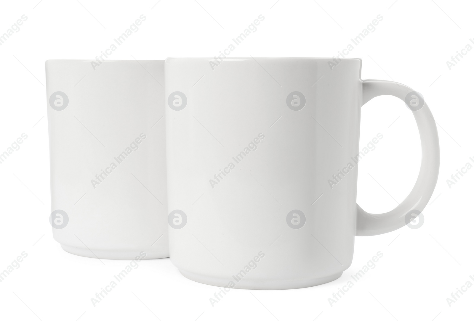 Photo of Two light ceramic mugs isolated on white