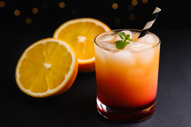 Photo of Fresh alcoholic Tequila Sunrise cocktail on grey table