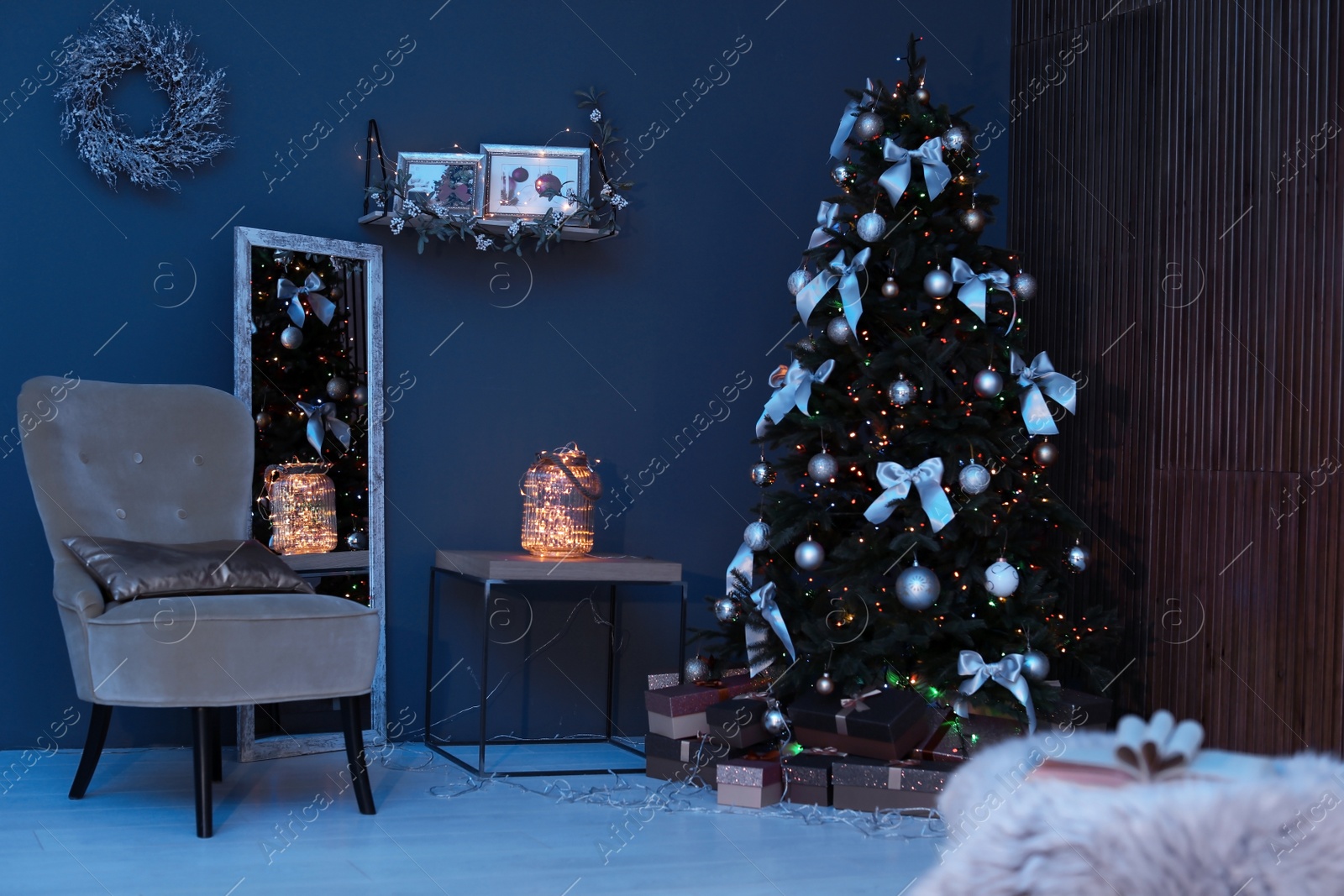 Photo of Room interior with beautiful Christmas tree and gifts