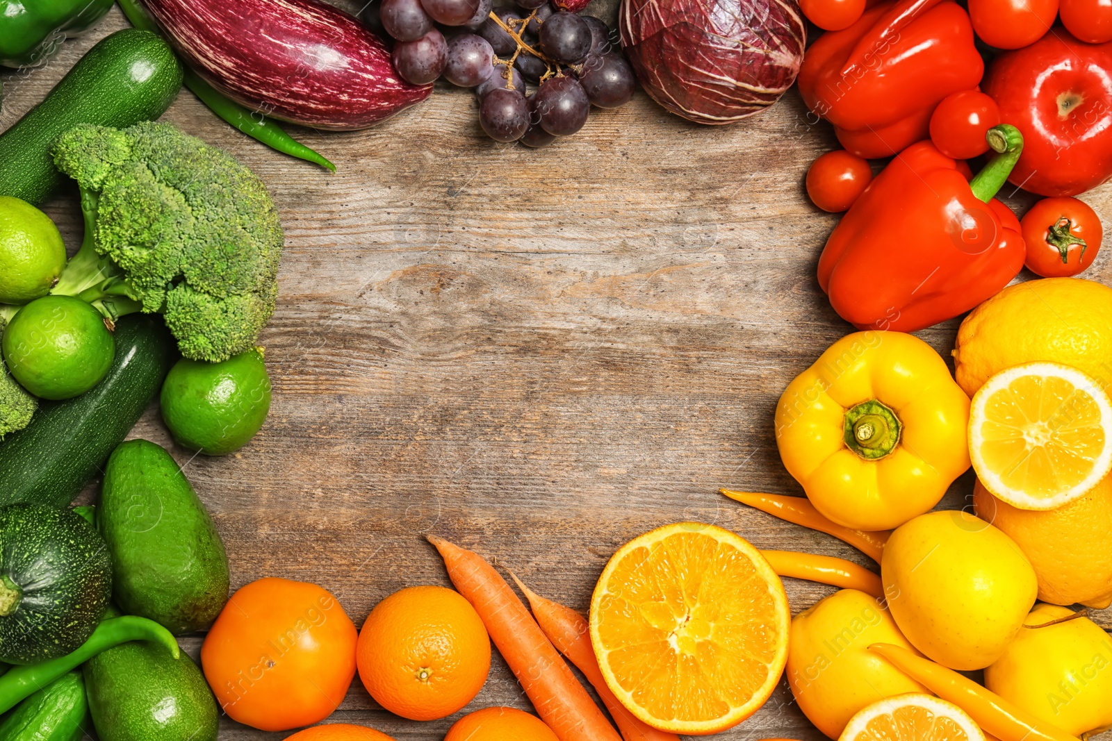 Photo of Rainbow composition with fresh vegetables and fruits on wooden background, flat lay