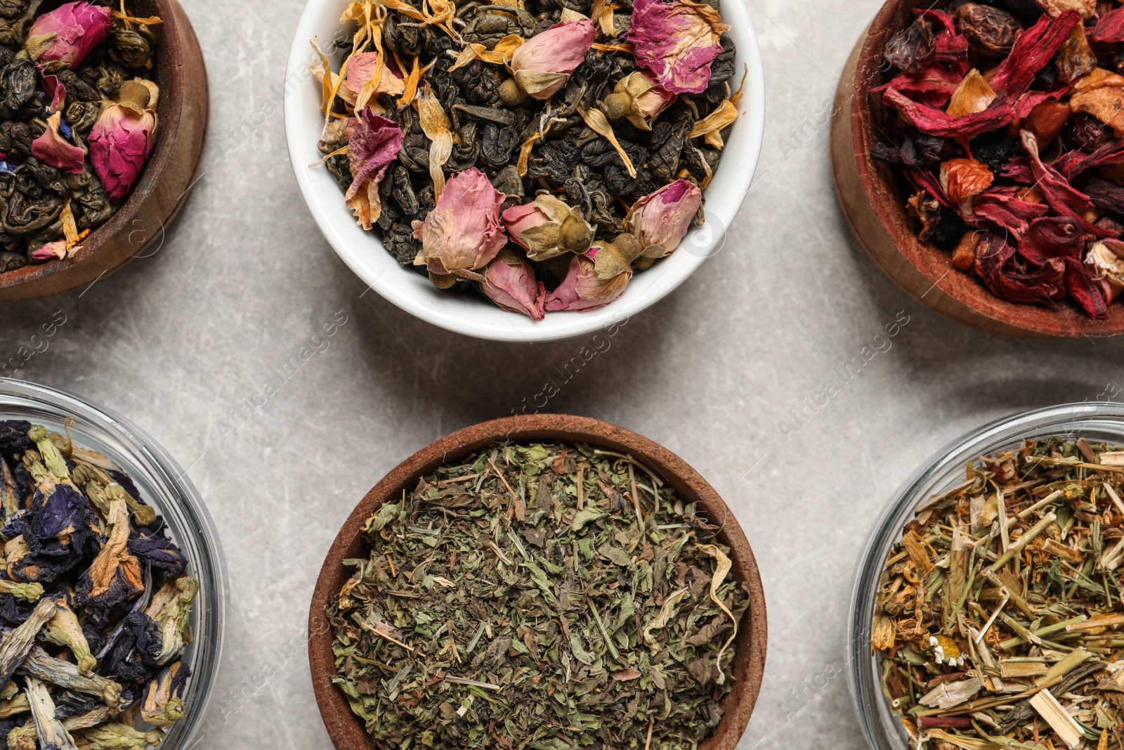 Photo of Flat lay composition with different dry teas on light table