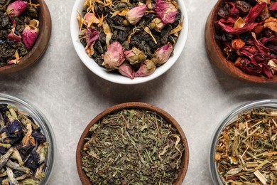 Flat lay composition with different dry teas on light table