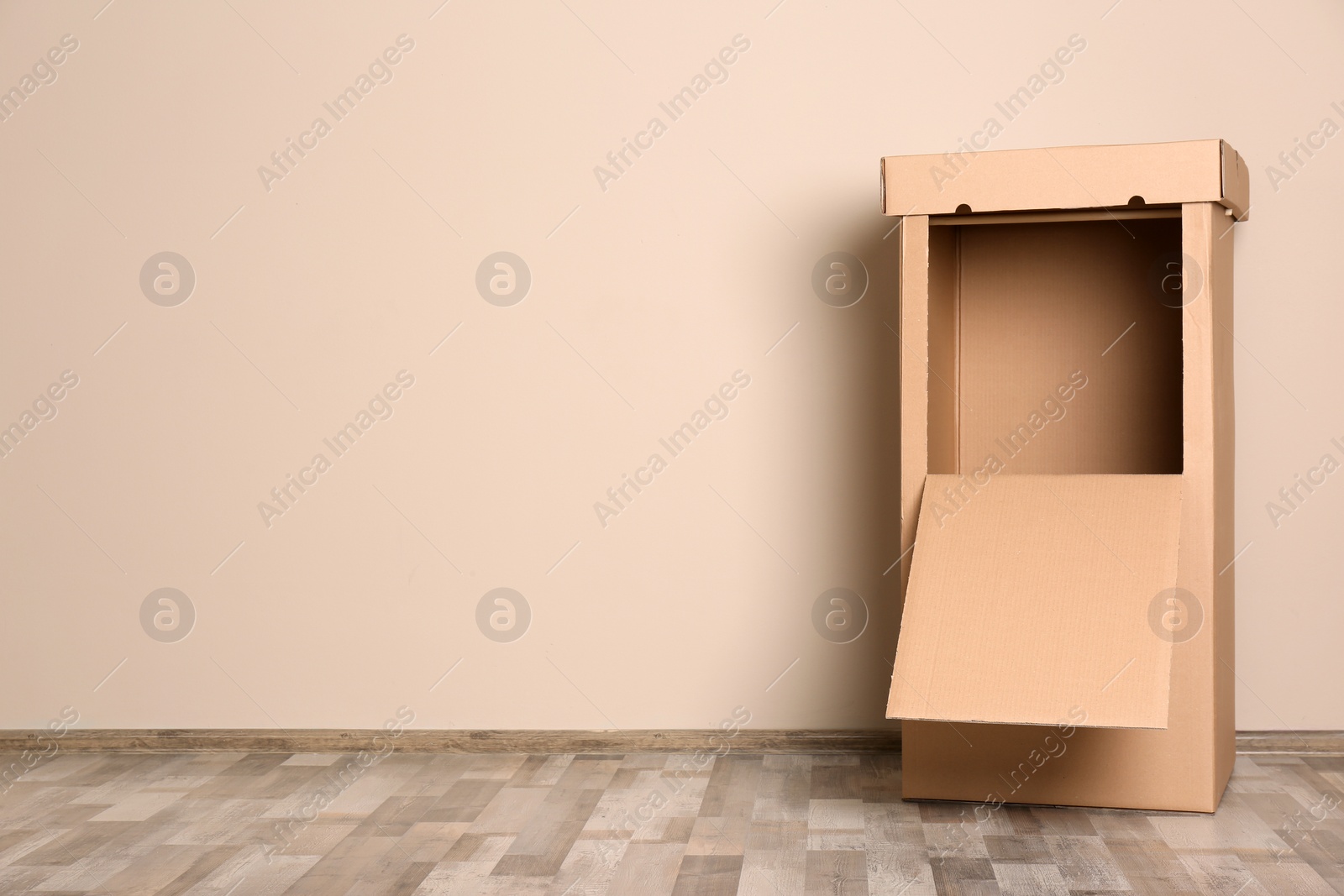 Photo of Empty wardrobe box against color wall indoors. Space for text