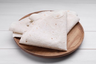 Photo of Delicious folded Armenian lavash on white wooden table