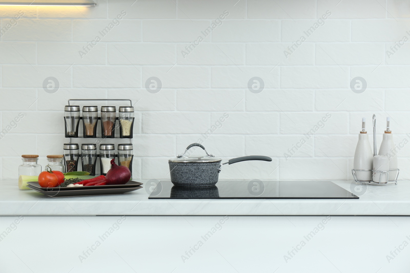 Photo of Saucepan, fresh vegetables and spices in kitchen