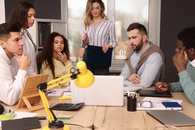 Photo of Team of employees working together in office. Startup project