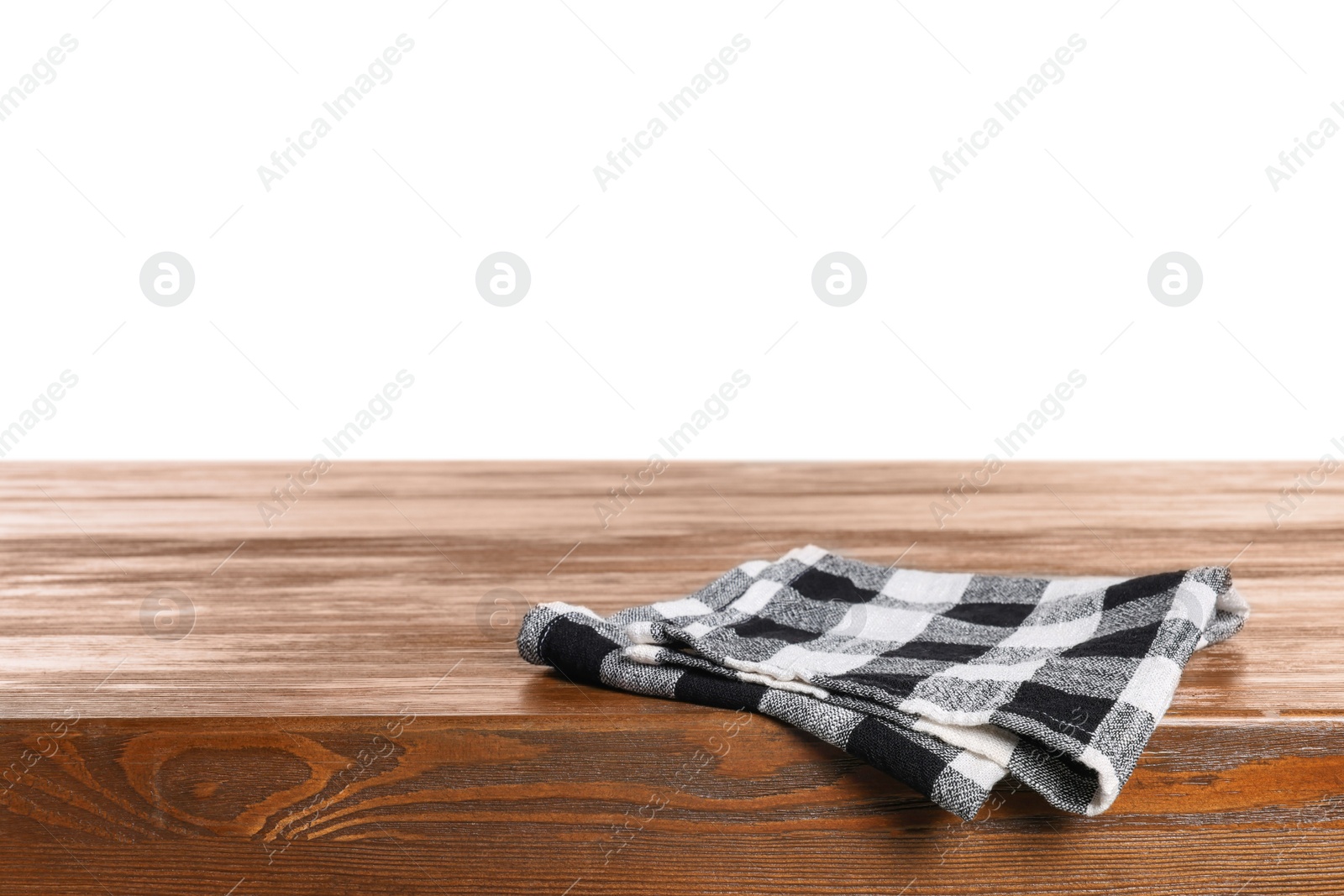 Photo of Checkered tablecloth on wooden table against white background