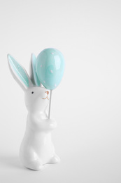 Bunny ceramic figure as Easter decor on white background